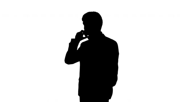 Silhouette Handsome young businessman talking on the phone.