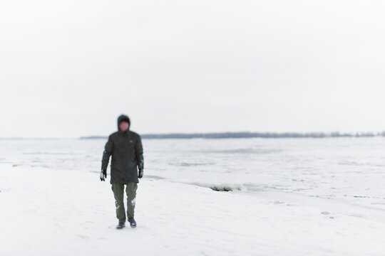 man with frozen river