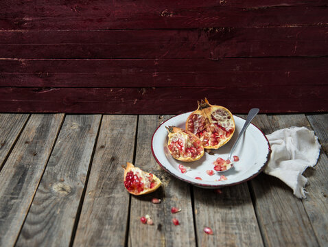 Pomegranate with wood maroon background
