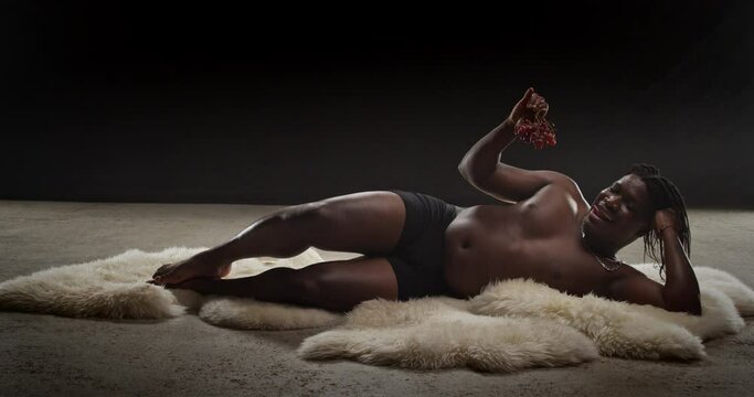Black Playboy Licking Lips With Grapes