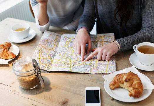 Detail of hands serching for directions on a map