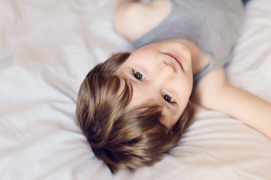 Close up of boy lying on a bed