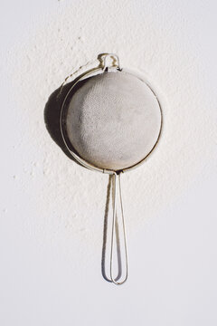 Strainer and Flour on White Beackground