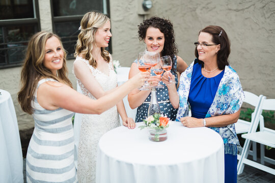 Cheers! Bride and bridesmaids with champaign glasses