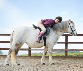 Young girl with her pony.