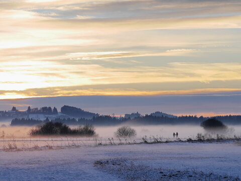 Couple walking in winter landscape