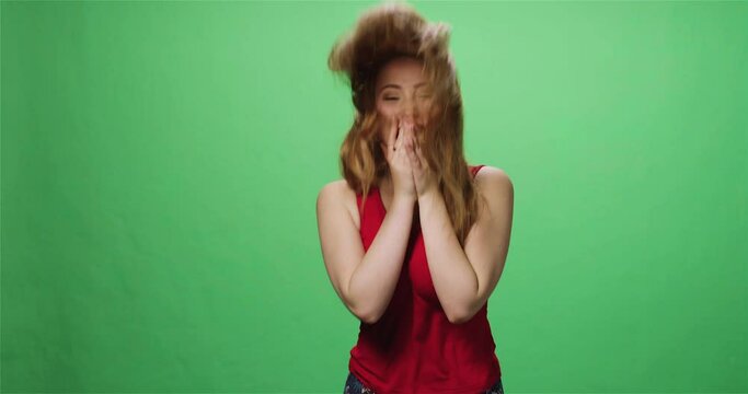 Redhead woman laughing and jumping, greenscreen, slow motion