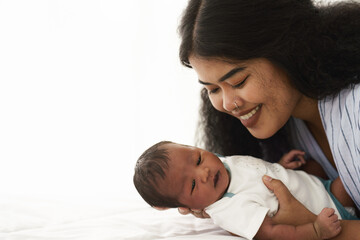 mixed race african american and asian mother holding newborn baby