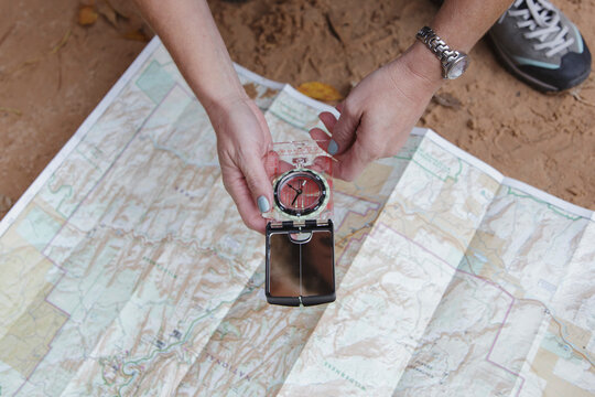 Woman holding a compass over a map