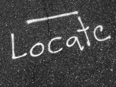 The word ""Locate"" written on urban street
