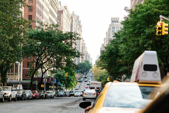 A yellow cab driving dowtown New York City