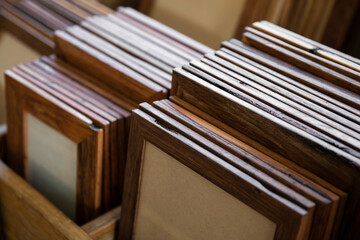 A collection of hand crafted wooden picture frames organised into groups by size and type of...