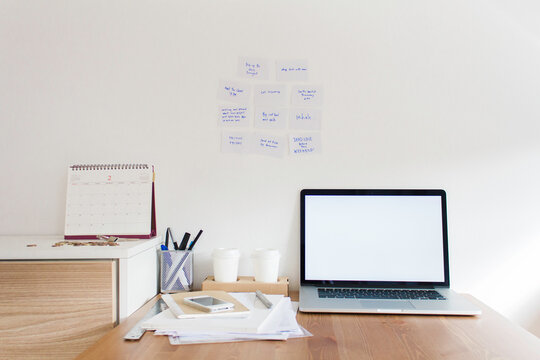 Busy mordern working table with office supply and electronic device on it