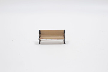 Brown wooden bench with a decorative ornate metal legs and armrests,
