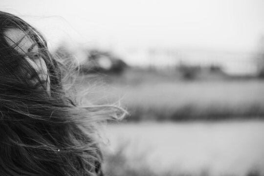 Portrait of a young woman with wind blowing hair