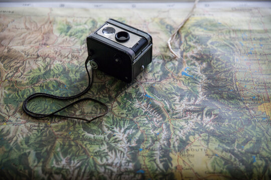 Vintage camera sitting on vintage American map