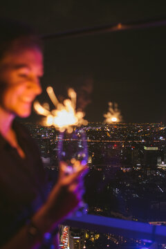 Out of focus - woman with a sparkler