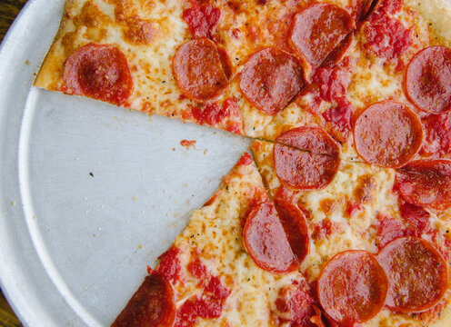 Pepperoni pizza with one slice taken out