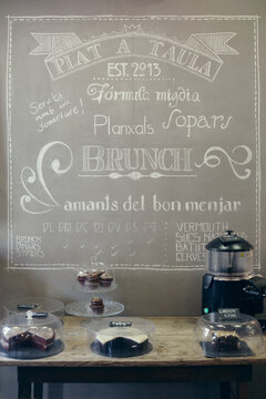 Cake corner of a coffee shop with wall written menu