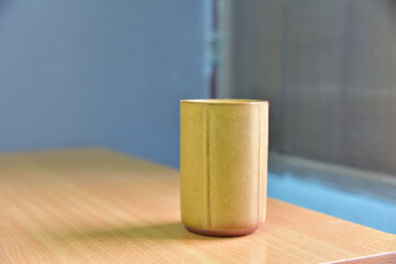 Vintage cup on wood table.