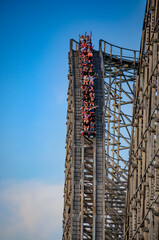 People enjoy onboard ride on a roller coaster