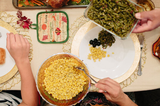 Passing around Thanksgiving sides at the dinner table