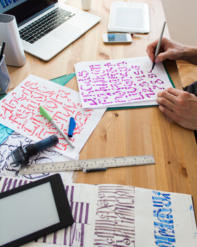 Freelance graphic designer creating new font collection by hand