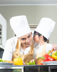 papa and son chef cooking in the kitchen during holiday