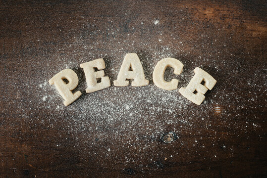 Shortbread Cookie Letters spelling out ""peace"" and splattered with flour