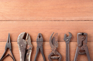 old tools on wood background with space for text or image / cerclip pliers, locking pliers, pliers,...