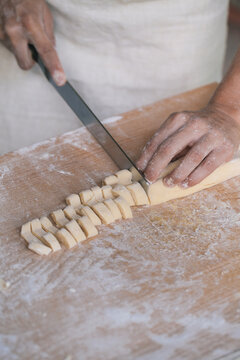 Woman cutting homemade fresh pasta