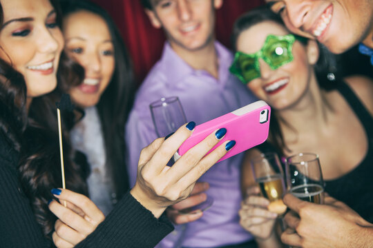 Party: Friends Check Out Selfie On Cel Phone