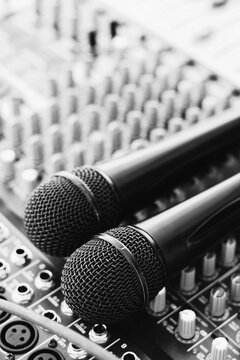 Close up of two microphones on audio mixer