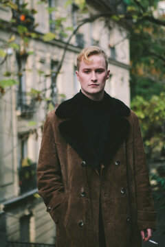 stylish blonde man wearing sheepskin coat