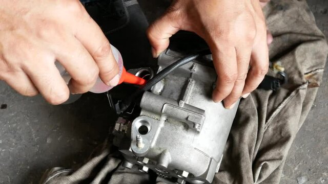 auto mechanic repair car air conditioner at service station.