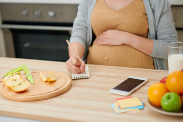 Pregnant woman preparing healthy food