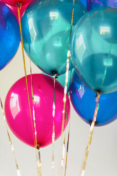 Bunch of multi colored balloons and golden sequin string