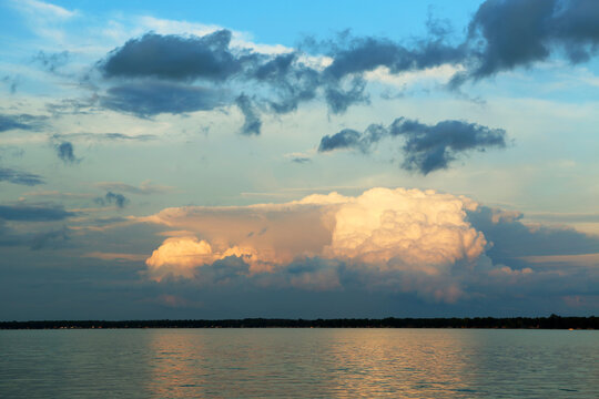 Large Cumulus Clouds Over A Lake On A Summer Evening