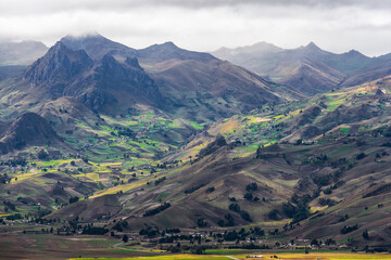 Dramatic high altitude Andes landscape with agriculture fields near Quito, Ecuador.