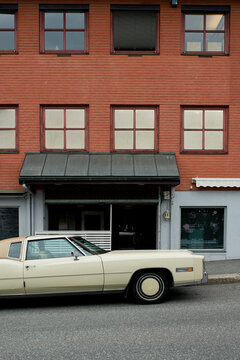 Vintage car parked in front of house wall