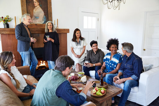 Group of friends and family having a cocktail party in their home