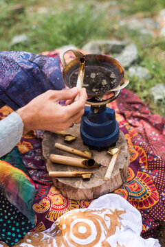 Close up of hippie man drawing some batik in nature