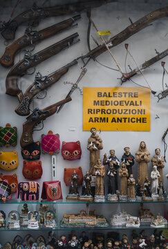 Gift shop window in Assis, Italy - featuring St. Francis and gun