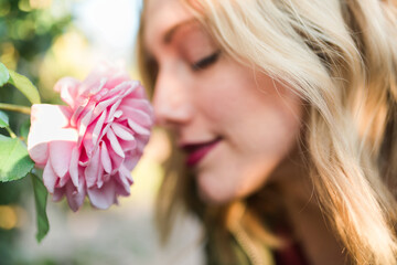 A woman smelling a rose