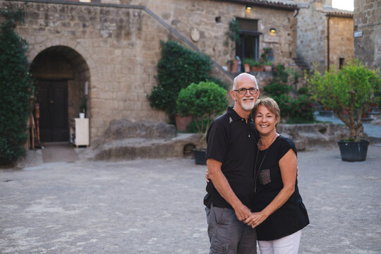 Happy middle age couple together in old Tuscan town