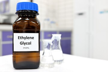 Selective focus of ethylene glycol liquid chemical compound in dark glass bottle inside a chemistry...