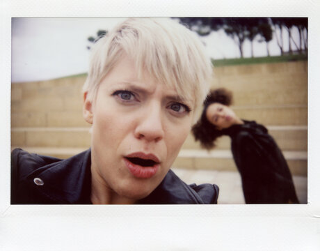 Portrait of blonde person looking at camera with surprise