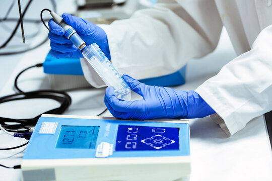 Chemist using a PH Meter