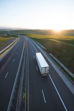 Truck driving on a interstate highway during sunset