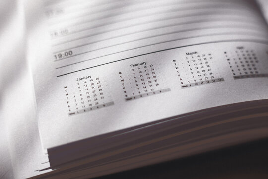 2015 leather personal black note book organizer on wooden background.